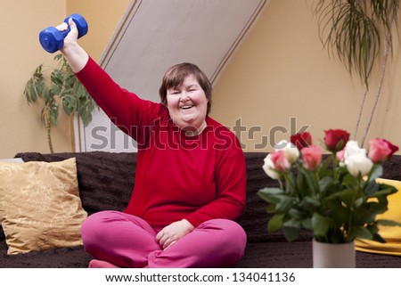 Mentally disabled woman shows her strength with a dumbbell