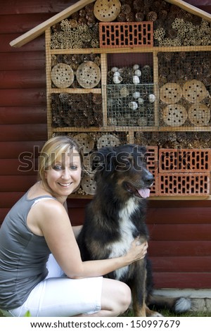 blond woman with dog showing insect hotel