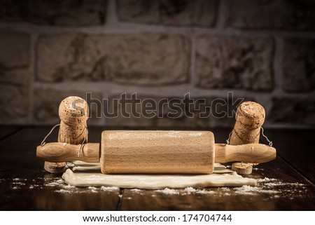 Concept baker to roll some pastry, wine cork figures