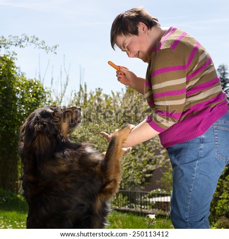 mentally disabled woman is feeding a dog