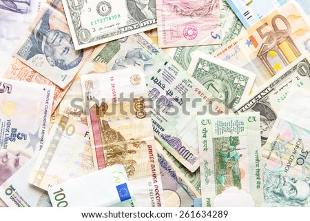 many different currencies as colorful background concept global money