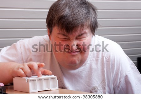 mentally disabled woman with some pills looks angry
