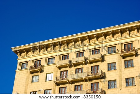 Top of the building. Roofs, balcony, windows and sky