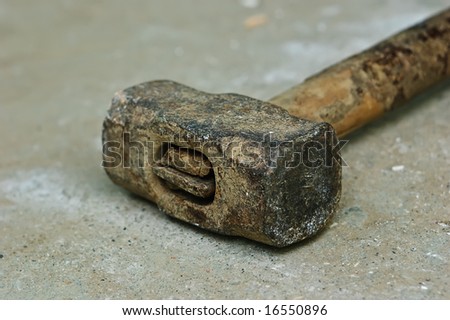 old iron hammer on concrete floor