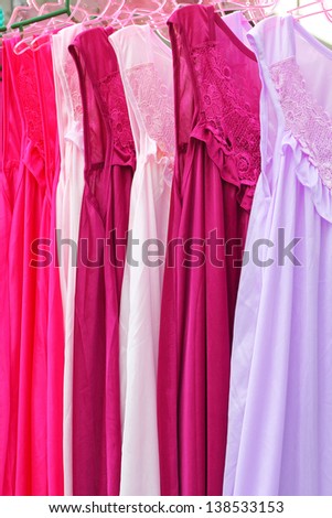 Colorful clothes on wooden hangers