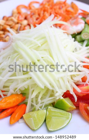 Papaya salad ingredients on wood background