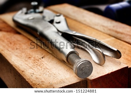 Adjustable wrench tool on wood background
