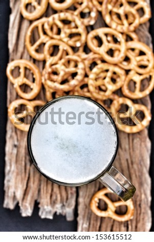 Cookies pretzels and beer on the wood background