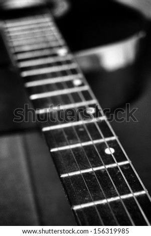 closeup of guitar on black background