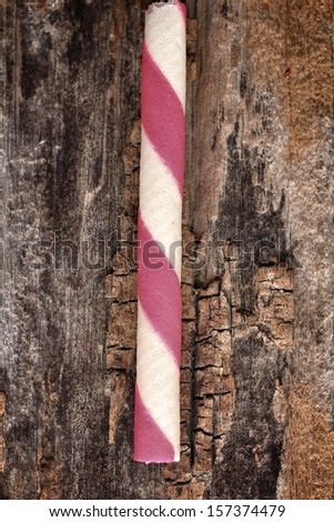 Wafer roll sticks on wood background