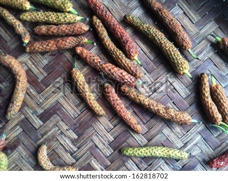 Indian long pepper on wood background