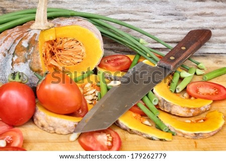 Slices of fresh pumpkins , onion flower and ripe tomato