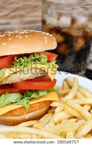 Close up of tasty hamburger, french fries and cola - Fast food