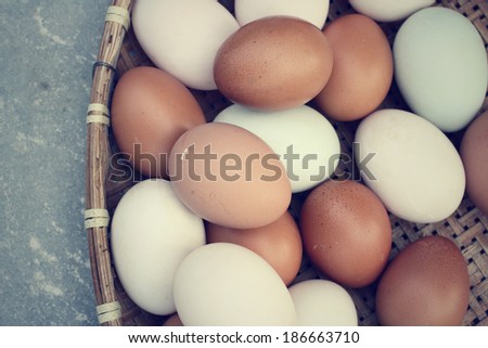 Mix of white and brown eggs in basket