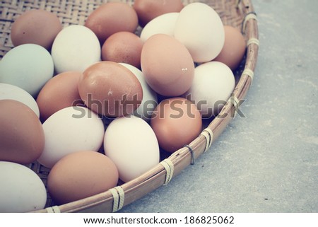 Mix of white and brown eggs in basket