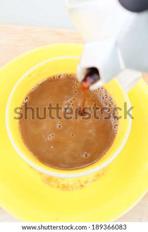 Pouring of coffee in italian coffee maker