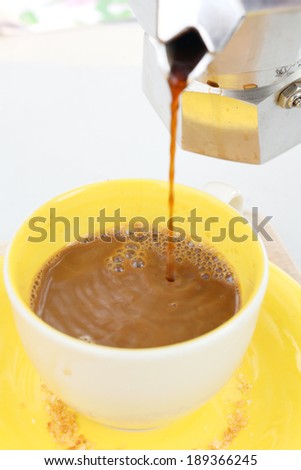 Pouring of coffee in italian coffee maker
