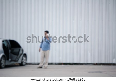 Blurred of man calling insurance after car accident