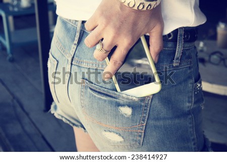 smart phone in jeans pocket