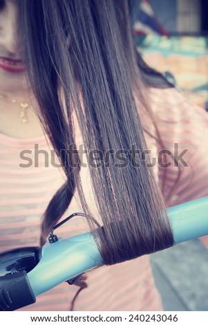 Woman using straightener with hair