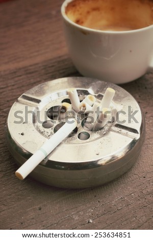 Cigarette with ashtray and hot coffee