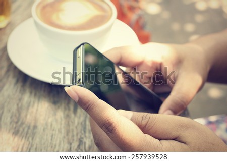 Vintage latte art coffee with smart phone