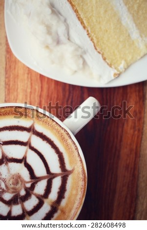 Vintage latte art coffee with cake