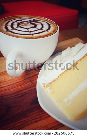 Vintage latte art coffee with cake