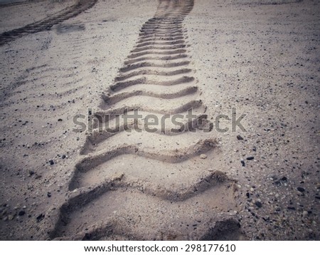Wheel tracks on the soil.