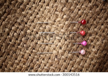 Sewing pins on sackcloth