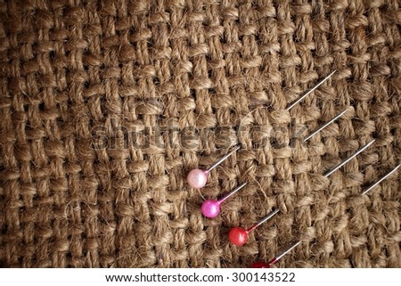 Sewing pins on sackcloth