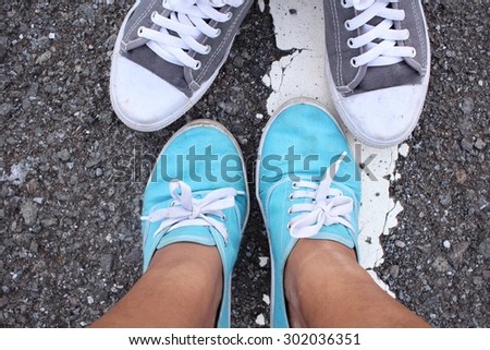 Selfie of sneakers with male and female couple