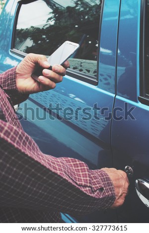 Man open the door car with smart phone