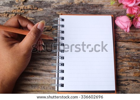 Woman with pen writing on paper