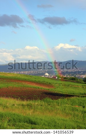beautiful rainbow photographed from the hills near the city
