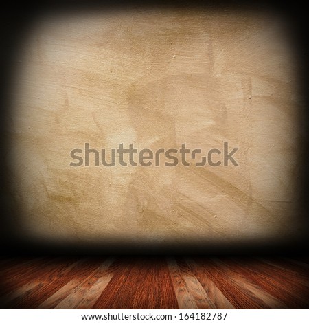 weathered cement wall and wood floor in indoor backdrop setting