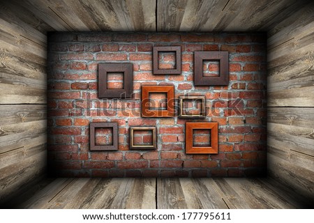 empty room with frames on abstract brick wall