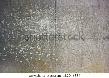 grungy concrete wall with many scratches on house foundation