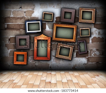 indoor backdrop with painting frames hung on old brick wall and place for your text, message or images