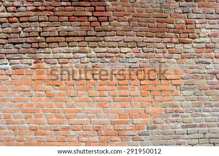 restoration on old fortress brick wall, texture with old and new material