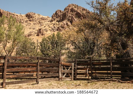 Old wooden cattle corrals in high desert landscape in United States of America/Wild West History/Handmade wooden cattle pens against rocky landscape