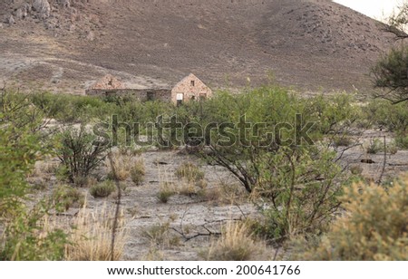 Roofless old homestead with rock and stone walls in semi-desert countryside/Lone Roofless Stone Building in Arid Countryside/Old roofless house built with rocks and stone