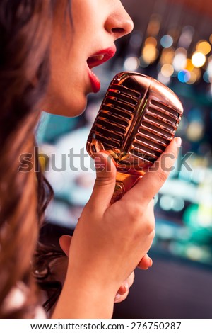 Woman sings in microphone