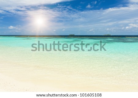 Beautiful crystal clear Maldivian sea and a blue sky with a sun