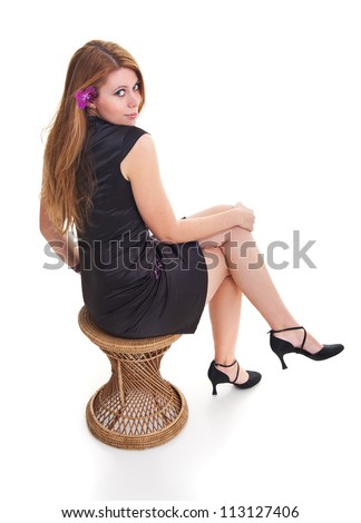 Young woman in the purple dress and orchid in her hair isolated on white