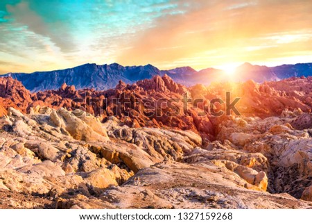 Amazing colors and shape of the sun setting over rocks in Fire Canyon, Valley of Fire State Park, Nevada, USA