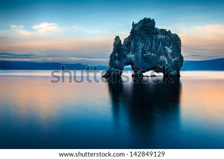 Hvitserkur Is A Spectacular Rock In The Sea On The Northern Coast Of Iceland. Legends Say It Is A Petrified Troll. On This Photo Hvitserkur Reflects In The Sea Water After The Midnight Sunset.