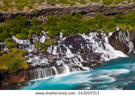Hraunfossar is a very beautiful Icelandic waterfall in the west of the island. It comes from the lava field and pours into the Hvita river with a incredibly blue water. Long exposure.