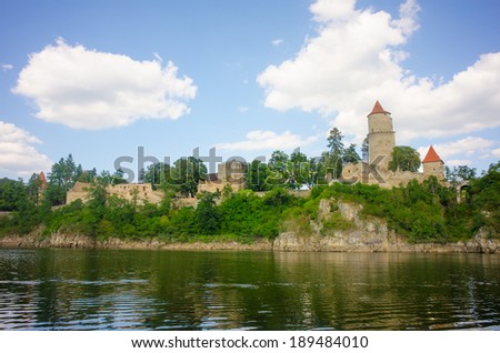 Medieval castle Zvikov in the Czech Republic with round tower, draw-bridge and blue sky seen from the river Vltava