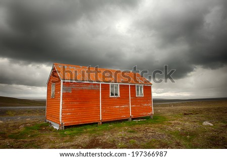 Old red snowstorm shelter can save a life in a cruel blizzard or in winter on Iceland